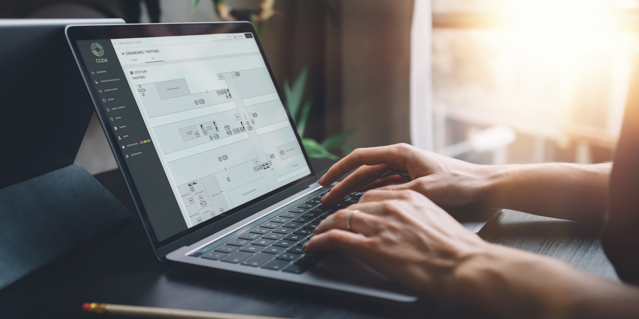 Woman using laptop, viewing CODA digital twin