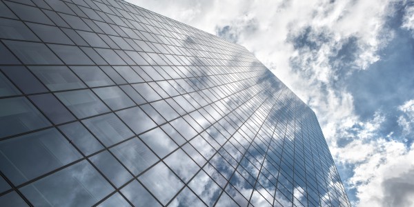 Exterior of building with with clouds reflecting in windows