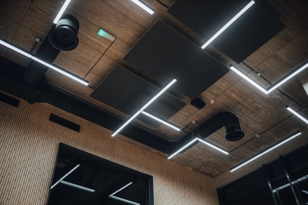 Ceiling of modent building with exposed air ducts and LED lighting strips